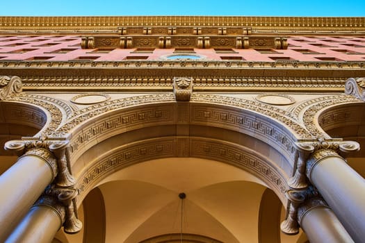 Image of Textured details in ceiling and wall of building with tall pillars