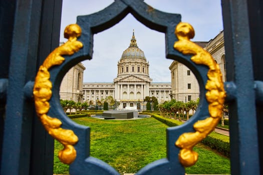 Image of Framed view of memorial court and city hall through fancy black and golden gilded lamppost