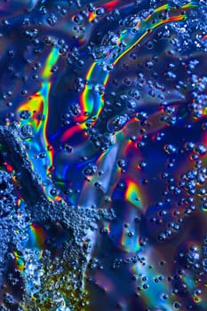 Image of Dazzling abstract art with bubbles flowing across colorful oily surface background asset