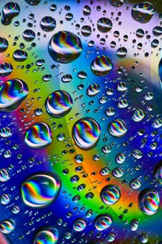 Image of Silvery swirling water drops in cosmic rainbow in psychedelic background asset