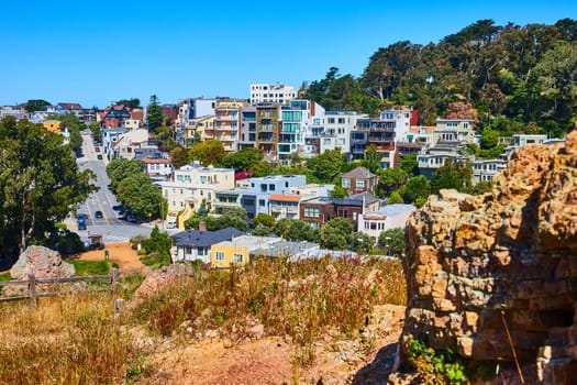 Image of Corona Heights Park with trail view of neighborhood on hillside with blue sky day