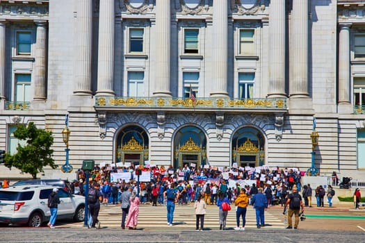 Image of Protestors gathering in front of government building city hall on bright summer day