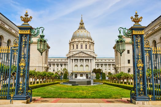 Image of San Francisco city hall memorial court with stone memorial view through gilded light posts