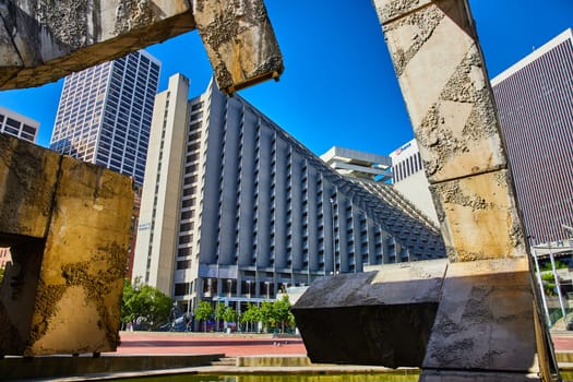 Image of Textured Vaillancourt Fountain with view of Embarcadero entrance and skyscraper buildings