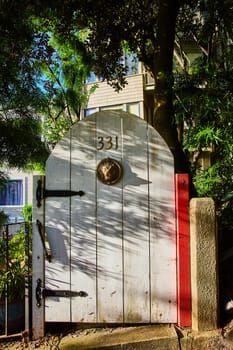 Image of Curved white door with black hinges and lion head entrance on door 331 entranceway