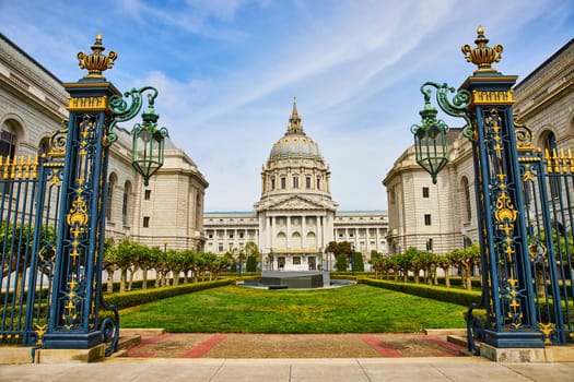 Image of Memorial court of San Francisco city hall with stone memorial view through gilded light posts