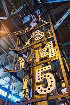 Image of Tall clock tower with mechanical people moving numbers one through five