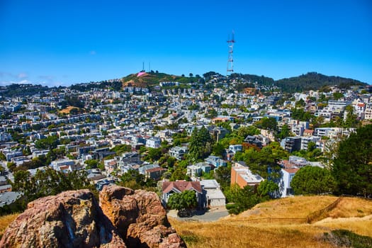 Image of Corona Heights view of city with Sutro Tower on distant hill on gorgeous blue sky day