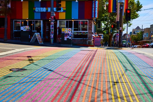 Image of Gyro Xpress store front with main view of rainbow crosswalk on bright sunny day