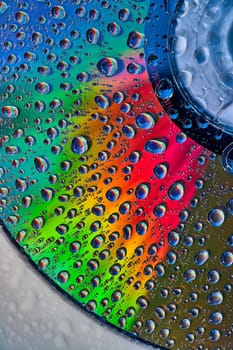 Image of Bright metallic surface with fizzy bubbles on abstract CD surface in background asset