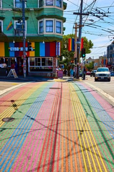 Image of Street view with rainbow crosswalk leading to Gyro Xpress on sunny day