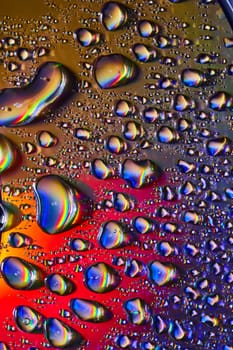 Image of Pop of color in dark with fizzy bubbles on reflective silver surface in abstract background asset