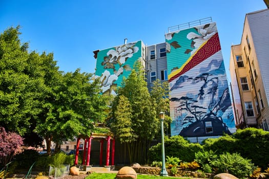 Image of Zen park with peaceful art mural on buildings and red Chinese pergola