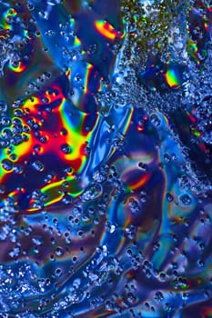 Image of Bright abstract art with bubbles flowing across colorful oily surface background asset