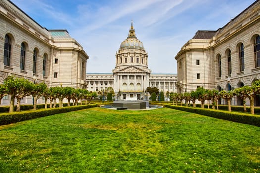 Image of Grassy green memorial court of San Francisco city hall with memorial on sunny day