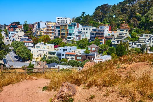 Image of Corona Heights Park trail leading to neighborhood of houses on hill