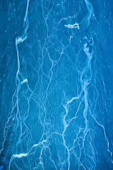 Image of Abstract lightning art on blue background with creamy white lightning vein strikes