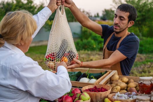 The farmer sells fruits and vegetables at the farmers market. Selective focus. Food.