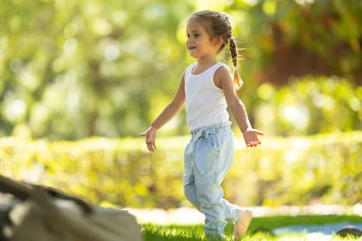 Cute little girl in the park. Mid shot