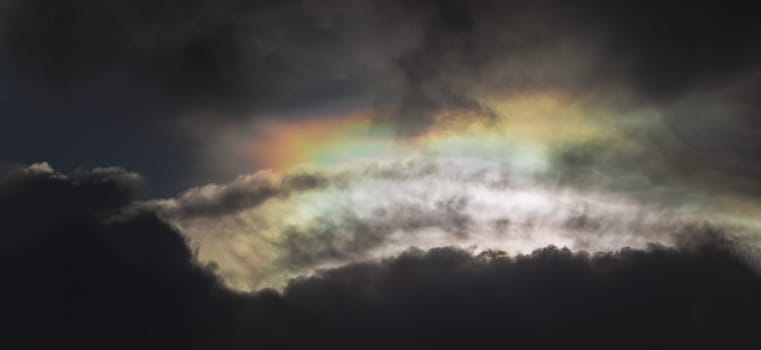 The sun's rays passing through the clouds and shining form an interesting light pattern against the sky. Amazing clouds like a heaven for background wallpaper and texture, Nature abstract composition, Panoramic shot, Selective focus.