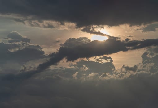 The sun's rays passing through the clouds and shining form an interesting light pattern against the sky. Amazing colors sky and clouds for background wallpaper and texture, Nature abstract composition, Selective focus.
