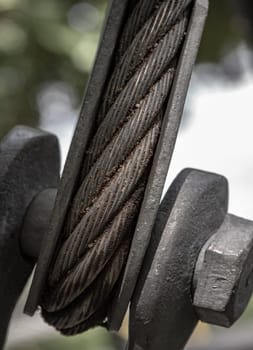 Close-up of Steel wire rope slings with Thimble and safety anchor shackle turnbuckle connection bolt for heavy work. Device for adjusting the tension or length cable, Metal ring and Steel cabling attached to a shackle, Space for text, Selective Focus.