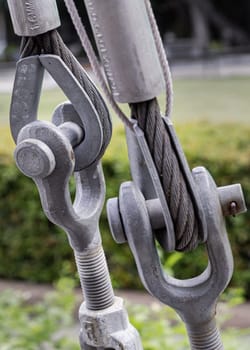 Steel wire rope slings with Thimble and safety anchor shackle turnbuckle connection bolt for heavy work. Metal ring and Steel cabling attached to a shackle, Device for adjusting the tension or length cable, Copy space, Selective Focus.