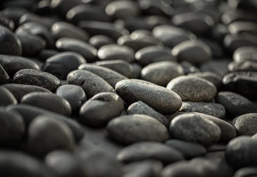 Close-up view of Black pebbles. Detail stone cobblestone as a background, Copy space, Selective focus.