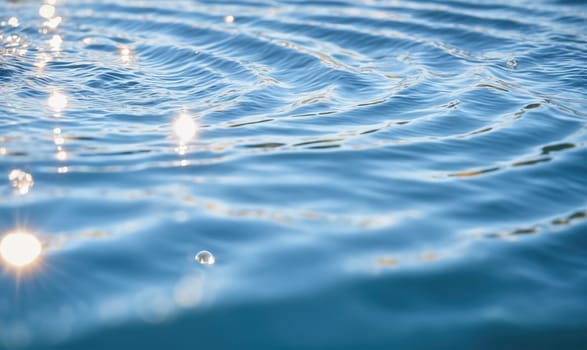 Calm, blue water with gentle waves reflecting sunlight.