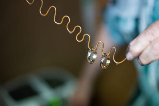 Wedding rings on wire after ultrasound ultrasonic bath. High quality photo