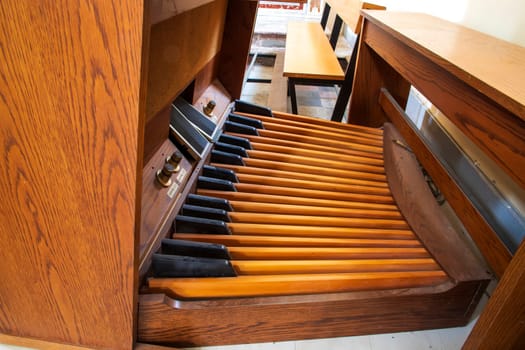 Wooden Keyboard and pedal organ close up.