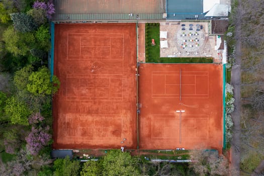 Clay courts for playing tennis in the park, aerial view. 