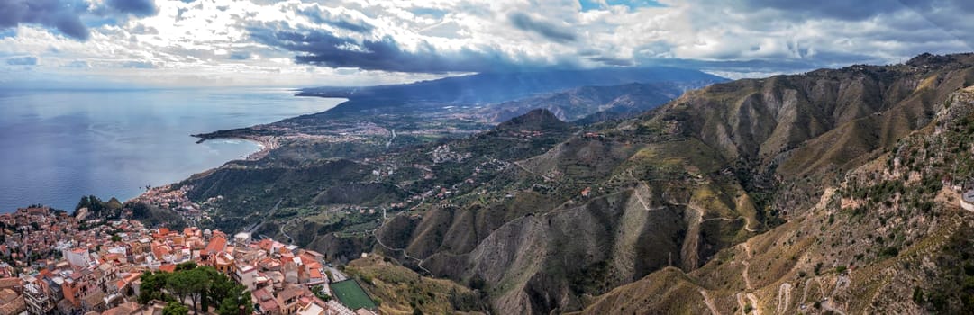 Stunning panorama of hills and the Sicilian coast from Castelmola in Sicily, Italy