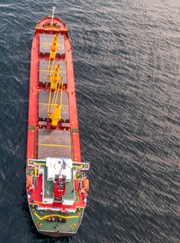 Aerial view of a container cargo ship on the sea. Cargo and shipping logistics business. Vertical view