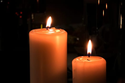 Two shiny Candles on black background