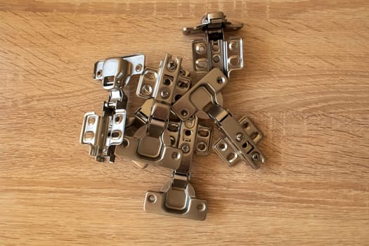 Many hinges on a table, ready for the Installation of furniture 
