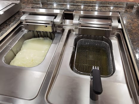 Big fryer for potatoes with cold and warm oil. Concept fast food restaurant,  kitchen equipment 