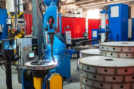 Automatic Industrial welding robot in a modern factory in operation.