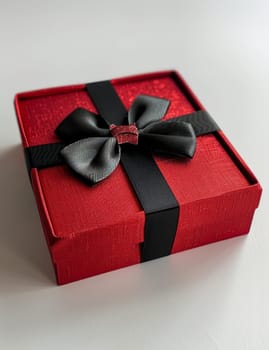 A vibrant red gift box with a satin ribbon lies on a textured white surface, evoking feelings of anticipation and celebration