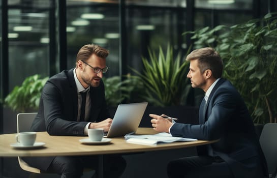Business people discussing a new project together sitting at the desk in an office, businessmen colleagues having a conversation at a meeting