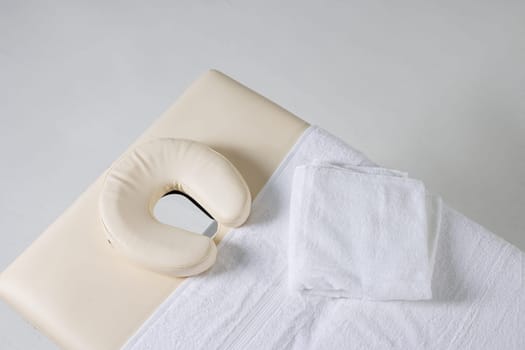 massage table top view on white background, massage therapist workplace, massage concept