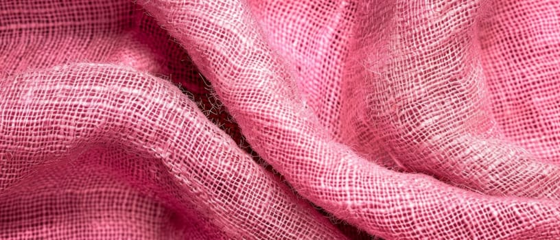 Macro shot of rippled pink fabric, with a focus on the intricate texture and soft waves creating a calming pattern. Burlap fabric texture - background.