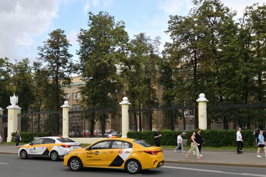 Moscow, Russia - July 15. 2024. Two Yandex taxis on the Leningradsky Prospekt