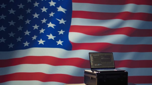 Laptop in CIA command center used by counterterrorism agents to run surveillance efforts against enemy of United States in conformity with Patriot Act law, isolated over USA flag, camera B
