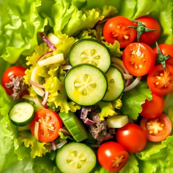 A colorful garden salad featuring vibrant cherry tomatoes, crisp cucumber slices, and fresh lettuce. The healthy mix showcases the freshness of summer produce.