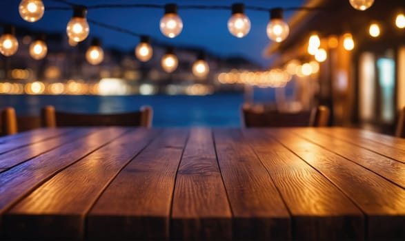 A wooden table with a smooth, polished surface sits in the foreground of the image. The table is illuminated by a string of lights that hang overhead, and the light creates a warm, inviting glow