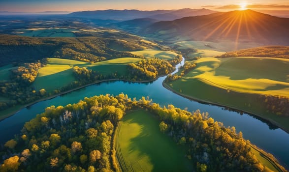A winding river snakes its way through green hills and forests, illuminated by the golden rays of the setting sun