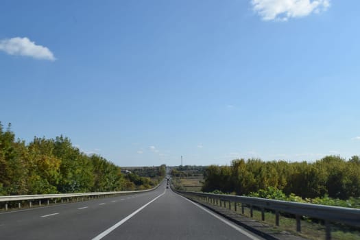 Country Road Landscape In Summer. Empty asphalt road and green tea plantation nature landscape.
