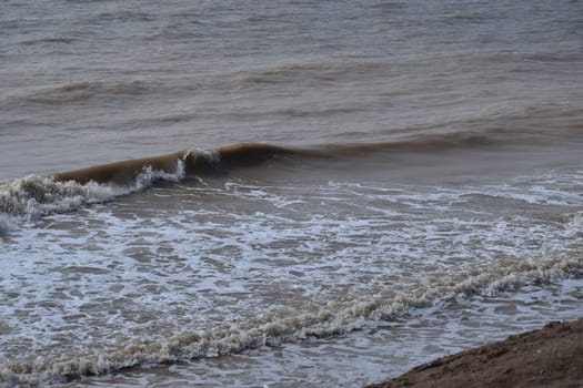 Sea serf of the Sea of Azov, the clay coast on a sunny day in summer.