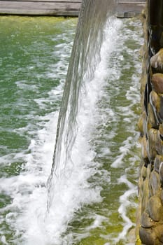 artificial waterfall, city fountain, close-up pouring water.